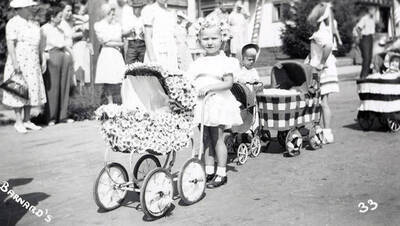 Children, who are in costume, pushing strollers during the Mullan 49'er parade in Mullan, Idaho.