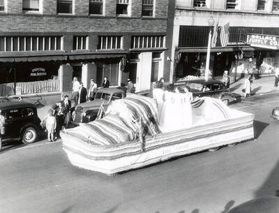 A group of women standing on a float being driven in the Elks Roundup parade in Wallace, Idaho.