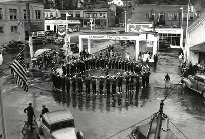 The Wallace High School Band playing at the Standard Station in Wallace, Idaho. This was taken at the time of the fireman's convention.