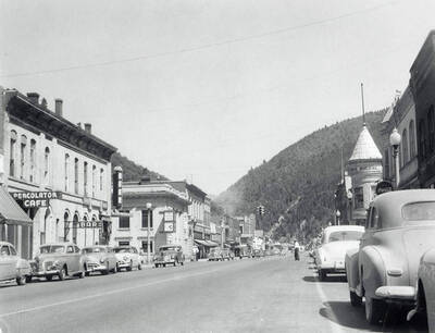 The view looking down Bank Street. Cars can are parked along the side of the street, in front of businesses.