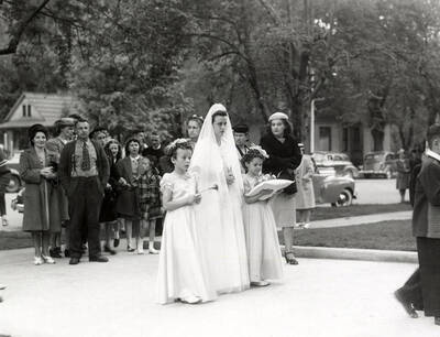 A group of people marching from the Our Lady of Lourdes Academy to the Church during the Blessed Virgin procession in Wallace, Idaho.