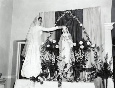 A girl crowning the Virgin Mary at Our Lady of Lourdes Academy in Wallace, Idaho.