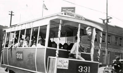 A float that looks like a trolley driving in the Elks parade in Wallace, Idaho.