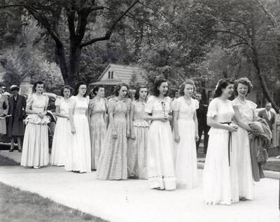 A group of women marching from the Our Lady of Lourdes Academy to the Church during the Blessed Virgin procession in Wallace, Idaho.