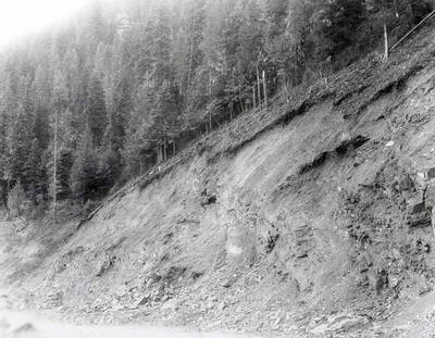 A photograph of an exposed roadside bank. Part of a Colonial Construction Company worksite.