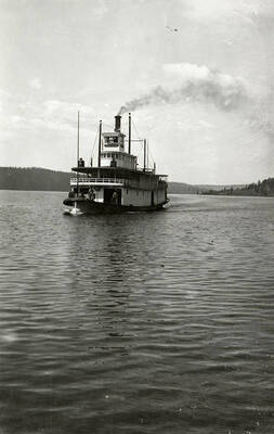 View of the Steamboat "Georgie Oakes" on Lake Coeur d'Alene. The steamboat was named after a daughter of the president of the Northern Pacific Railroad Company.
