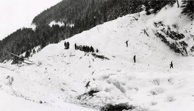 People walking atop the snow slide in historical Yellow Dog, Idaho.