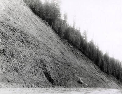 A photograph of an exposed roadside bank. Part of a Colonial Construction Company worksite.