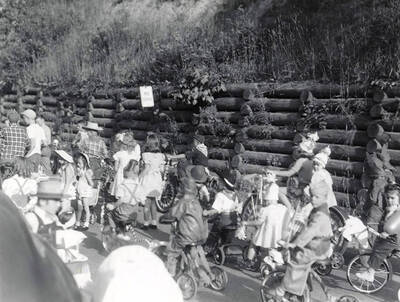 Children in costume riding bicycles during the Slippery Gulch parade in Wallace, Idaho.