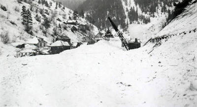 A crane working to remove snow after the snow slide in Mace, Idaho.