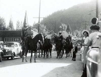 Men riding horses in the Mullan 49'er Parade in Mullan, Idaho.