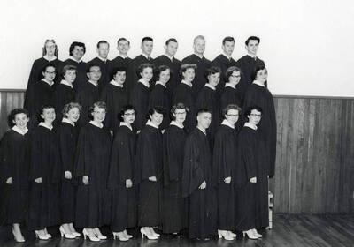 Group photo of the graduating class at Wallace High School in Wallace, Idaho. Back row (left to right): Aljean Wickberg, Violet Ban, Richard Christopherson, Ralph Pribble, Ken Truesdell, Jim Curtis, Bill Jacobson, Bill Lindroos, Terry Murphy. Middle row (left to right): Ruby Raber, Kay Tiffney, Terry Storjohann, Betty Bentham, Christy Terrill, Sara Ann Cooke, Dolores Erickson, Wanda Wolfgram, Mimi Deshler, Lillian Helgeson. Front row (left to right): Barbara Riegel, Gerry Drinnon, Mary Anna Trickey, Carol Anderson, Cecelia Montoya, Charlotte Carlson, Maureen Allen, Don Hogan, Milli Grant, Bette Jane Olson.