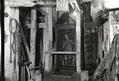 A man standing on the hoist in the Silver Dollar Mine in Osburn, Idaho.