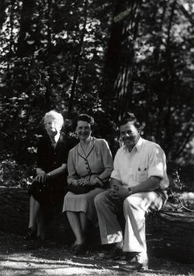 Nellie Stockbridge (on left) sitting on a log next to a man and a women during the Heilbronner Family Missoula trip.