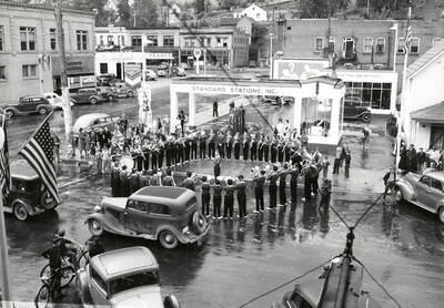 The Wallace High School Band playing at the Standard Station in Wallace, Idaho. This was taken at the time of the fireman's convention.