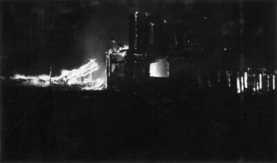 Night time image of the fire burning buildings in Wallace, Idaho. Forest fire 1910.