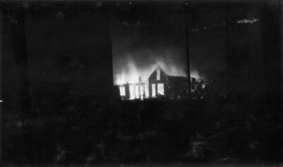 Night time image of the fire burning buildings in Wallace, Idaho. Forest fire 1910.