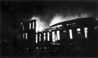 Night time image of the fire burning buildings in Wallace, Idaho. Forest fire 1910.