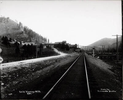 Distant view looking down railroad tracks at Gold Hunter Mill outside Mullan, Idaho.