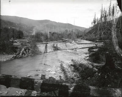 North side, Coeur d'Alene Mining District (Murray area). The legs of the camera stand are visible in the shadows on the water in the bottom portion of the photograph.