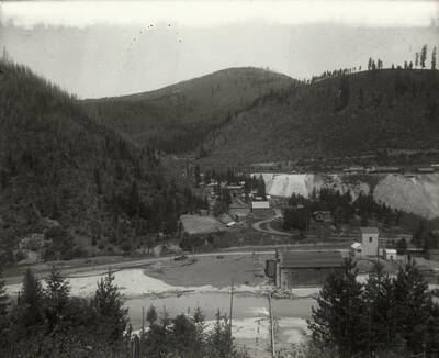 This gulch is just west of the Morning Mill. The lower houses were demolished to extend the waste rock pile as it grew. The photo was taken for Mr. Strode, the proprietor of Mullan Water Company.