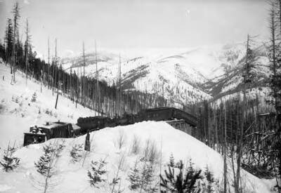 Image shows a train wreck on S Bridge, 1903, above Mullan, Idaho.