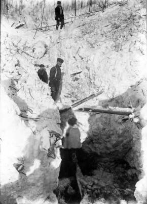 Workers assessing damage from a snow slide near Wallace, Idaho.