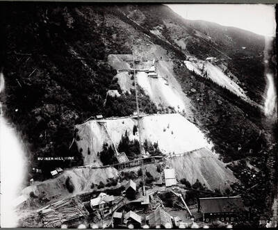 A mine up against a very sloped dirt like hill