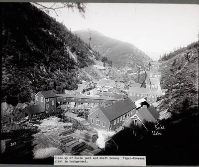 Caption on Front: Close up of Hecla yard and shaft house; Tiger-Poorman plant in background