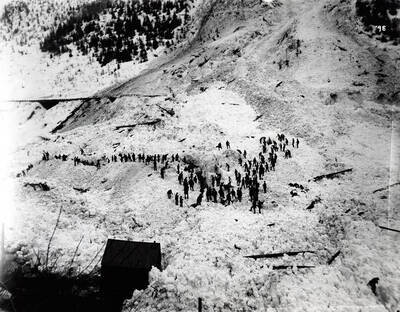 Image shows people gathered on the remains of a snow slide on March 29 in Black Bear, Idaho [1894].