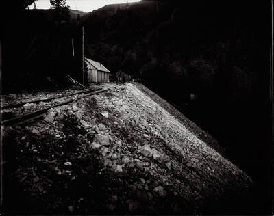 Building next to a hill of rocks