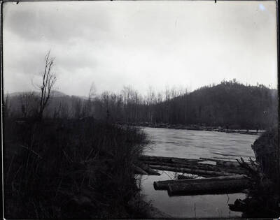 Picture of a river with a small dam at the bottom right