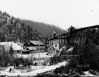 Image of the mill at Empire State Mining and Developing Co., toward the mouth of Government Gulch. Caption on back: "Located 3 miles west of Kellogg and 3 miles northwest of Wardner. (Sanborn map)."