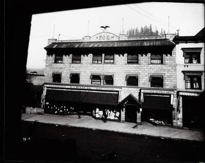 Exterior view of the Eagles block in March 1908, also shows Wallace Supply Co., W.J. Baker Co., and other offices in Wallace, Idaho.