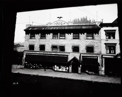 Exterior view of the Eagles block in March 1908, also shows Wallace Supply Co., W.J. Baker Co., and other offices in Wallace, Idaho.