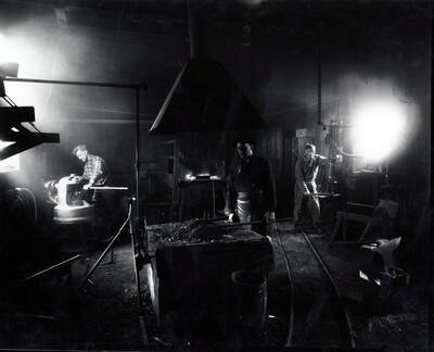 Image shows a men working in a blacksmith shop at the Amazon Dixie Mine in Sildex, Montana, 1923.
