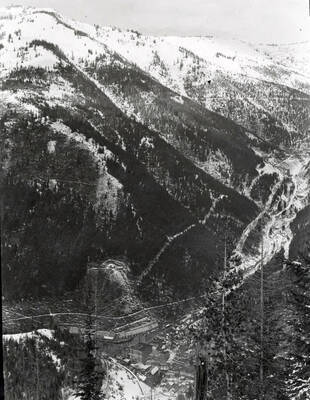 Distant view of snow covered Burke, Idaho set in the valley.