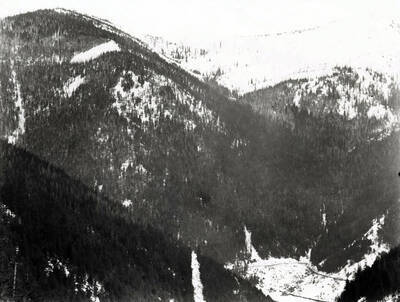 Distant view of snow covered Burke, Idaho set in the valley.