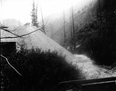 Image shows large dirt pile going down to creek, which runs next to mine.