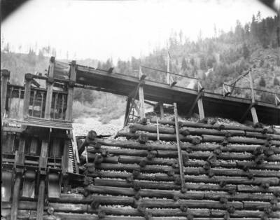 Image shows retaining wall for mine along railroad tracks.