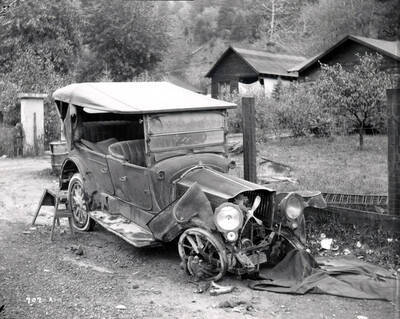 Image shows an automobile in disrepair. Note on back: H.E. Davis, auto accident
