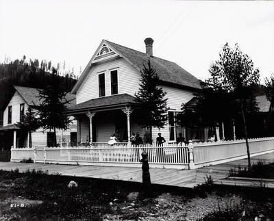 Image shows T.N. Barnard standing at his residence in Wallace, Idaho [1898] with a group of people. Mr. Barnard was a photographer and the owner of Barnard's Studio in Wallace, Idaho.