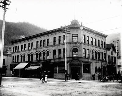 Exterior view of the Wallace National Bank in Wallace, Idaho on the corner of 6th and Cedar. Caption on front: "6th and Cedar"