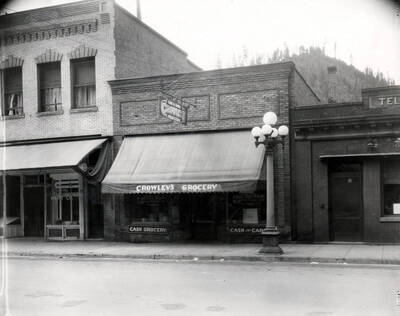 Exterior view of Crowley's Grocery, a Cash and Carry, a part of the Morrow Retail Stores in an unknown location, Idaho, 1925.