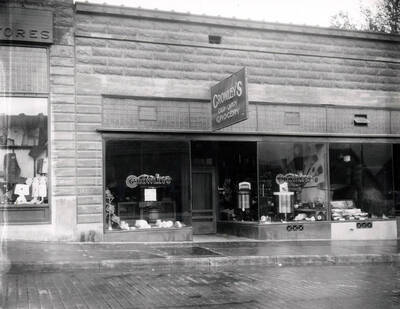 Exterior view of Crowley's Grocery, a Cash and Carry, a part of the Morrow Retail Stores located on Bank Street in Wallace, Idaho, 1925.
