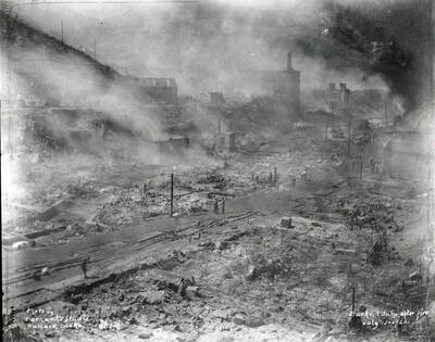 Images shows smoke rising from the smoldering ground in Burke after the fire July 13, 1923 which destroyed Hecla Mine.