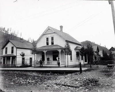 Image shows T.N. Barnard standing at his residence in Wallace, Idaho [1898] with a group of people. Mr. Barnard was a photographer and the owner of Barnard's Studio in Wallace, Idaho.