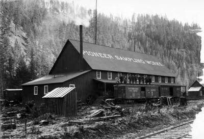 Pioneer Sampling Works building, Men standing on top of a railroad cart