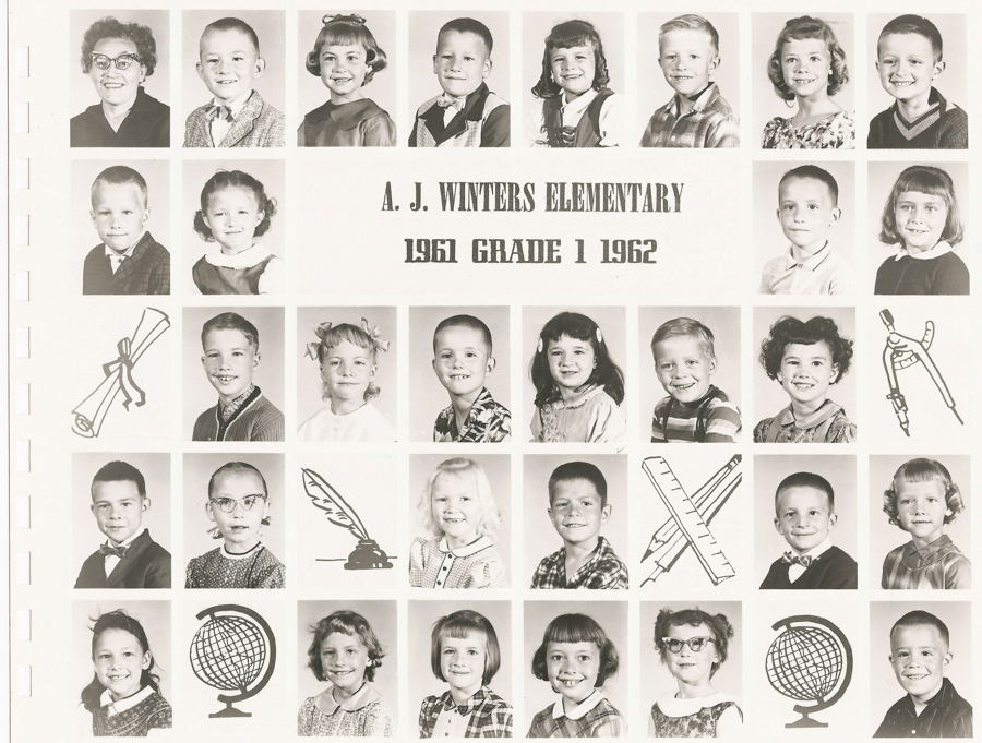 Rows of individual portraits featuring children and one adult, likely a teacher, arranged in a grid. The text reads "A. J. Winters Elementary 1961 Grade 1 1962". Between some rows, there are illustrations of a diploma, quill and ink, a compass, globe, and crossed rulers.