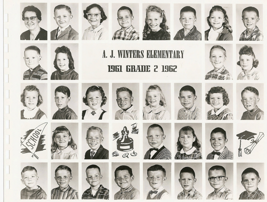 Grid of individual portraits featuring young children and one adult, likely a teacher, arranged in five rows. The third row has a label in the middle: "A. J. Winters Elementary 1961 Grade 2 1962." There are illustrated graphics of a school pennant, a school bell, and a graduation cap with a diploma on the bottom and second rows. Each child is dressed in early 1960s-style clothing.